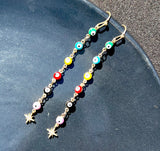 Long star evil eye earrings