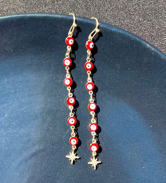 Long star evil eye earrings