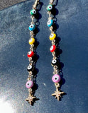 Long star evil eye earrings